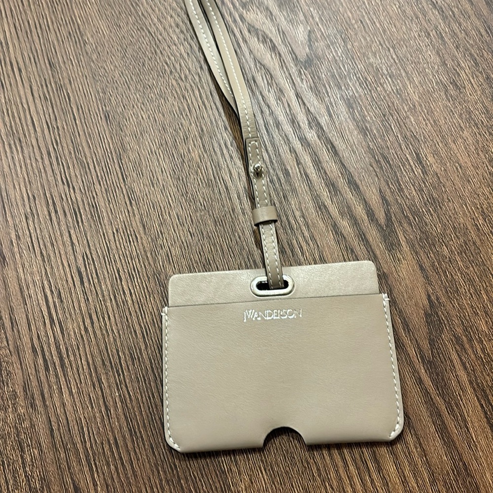 JW Anderson beige leather card holder with lanyard.